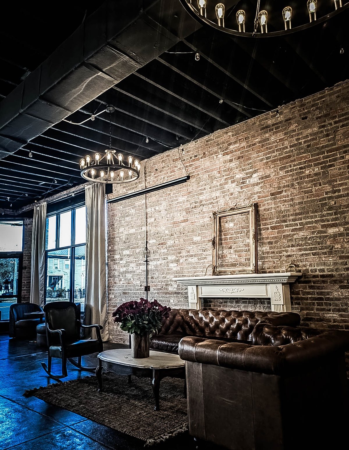 The lounge at The Cove: exposed brick, leather chesterfields and Edison chandeliers